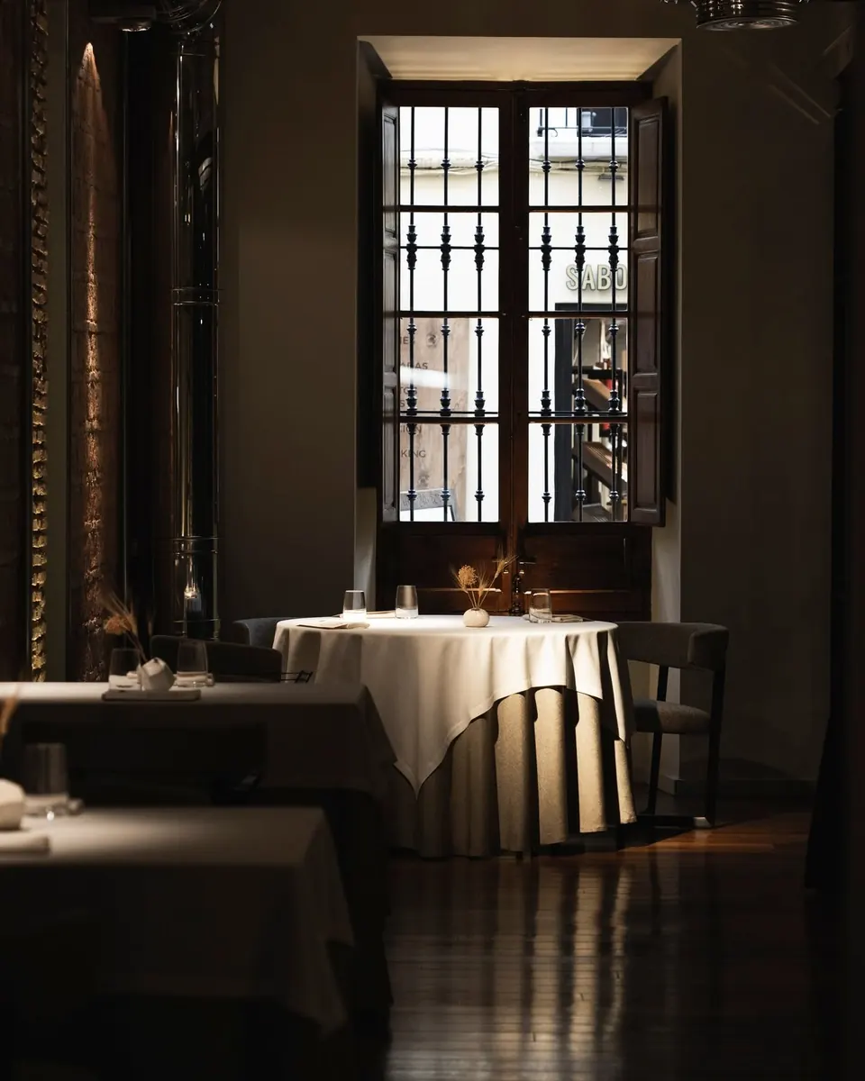 La sala de Bardal, con mesas vestidas y una ventana enrejada